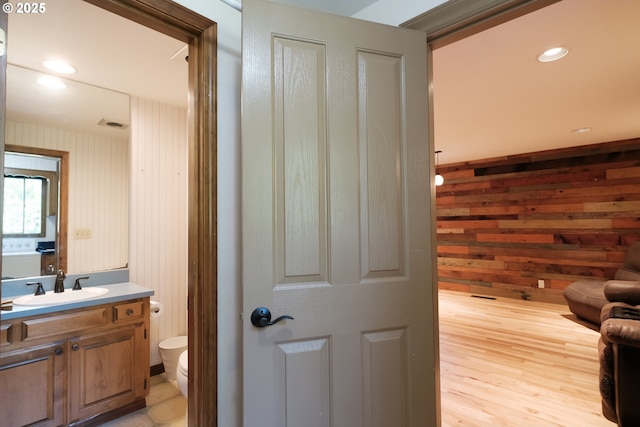 4635 18th Pl S, Salem, OR 97302 - bathroom featuring toilet, vanity, wooden walls, wood finished floors, and recessed lighting