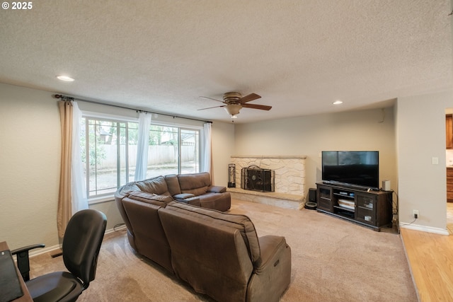 4635 18th Pl S, Salem, OR 97302 - living area with a ceiling fan, a textured ceiling, recessed lighting, a stone fireplace, and baseboards