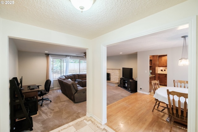 4635 18th Pl S, Salem, OR 97302 - office featuring light carpet, a fireplace, a textured ceiling, and baseboards