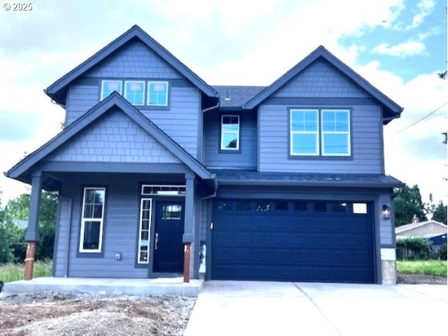 craftsman inspired home featuring a porch, an attached garage, and driveway