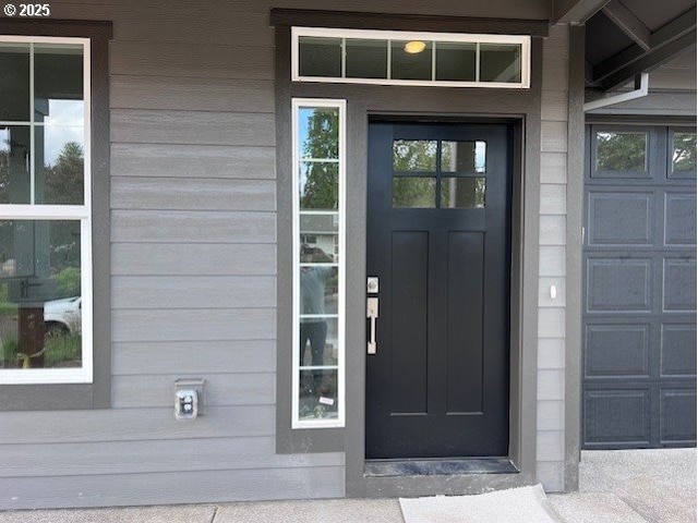doorway to property with a garage