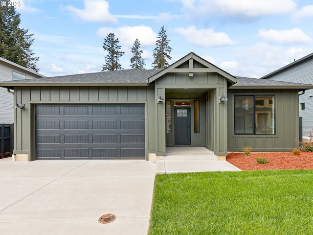 ranch-style house with a shingled roof, an attached garage, board and batten siding, a front lawn, and driveway