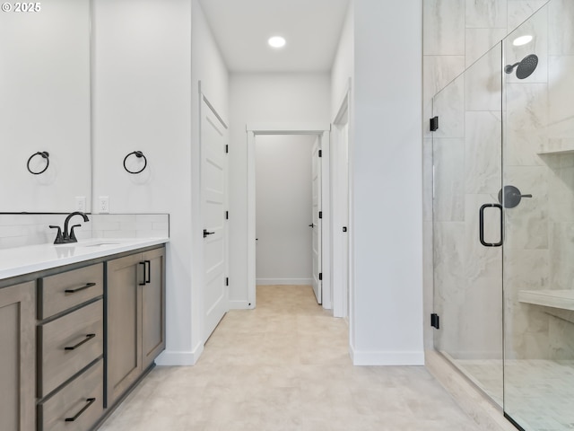 full bath with recessed lighting, vanity, baseboards, and a stall shower