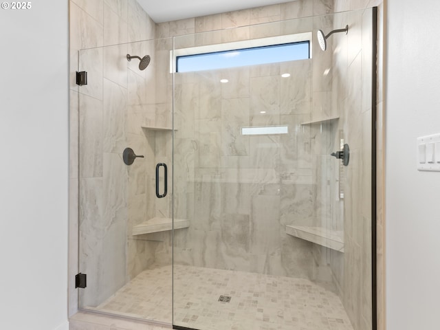 full bathroom featuring a stall shower and a healthy amount of sunlight