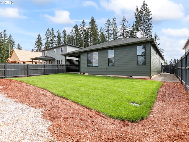 back of house featuring a yard and a fenced backyard