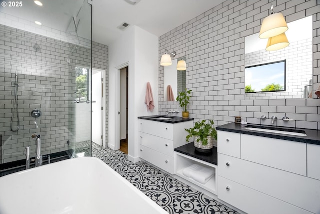 3419 SE Woodward St, Portland, OR 97202 - bathroom featuring vanity, a shower stall, a soaking tub, tasteful backsplash, and recessed lighting