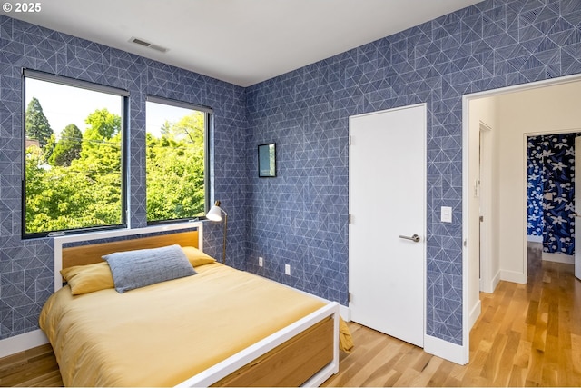 3419 SE Woodward St, Portland, OR 97202 - bedroom with light wood finished floors and baseboards