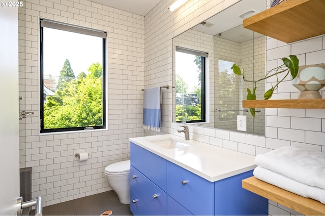3419 SE Woodward St, Portland, OR 97202 - bathroom with tile walls, plenty of natural light, vanity, and tile patterned floors