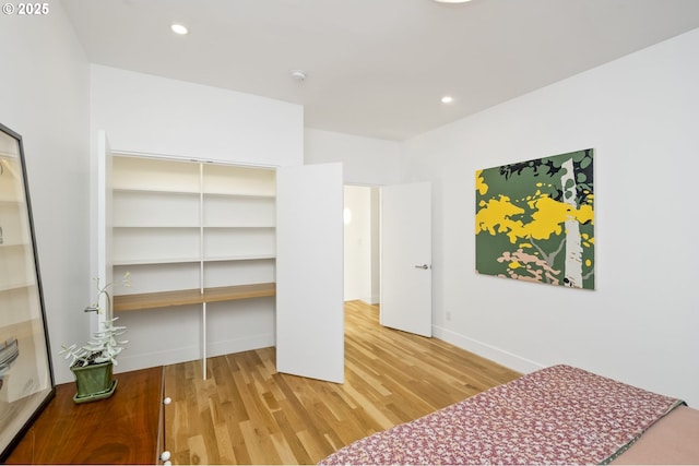 3419 SE Woodward St, Portland, OR 97202 - unfurnished bedroom with wood finished floors, a closet, and recessed lighting