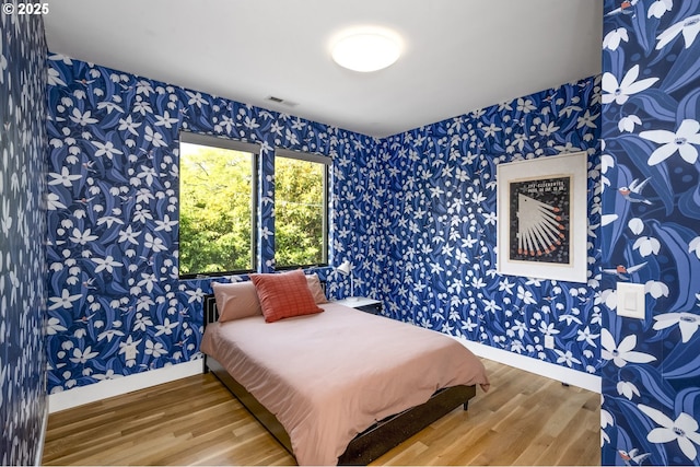 3419 SE Woodward St, Portland, OR 97202 - bedroom with wallpapered walls and wood finished floors