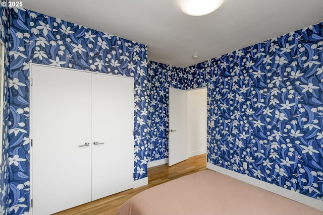 3419 SE Woodward St, Portland, OR 97202 - bedroom featuring wallpapered walls and wood finished floors