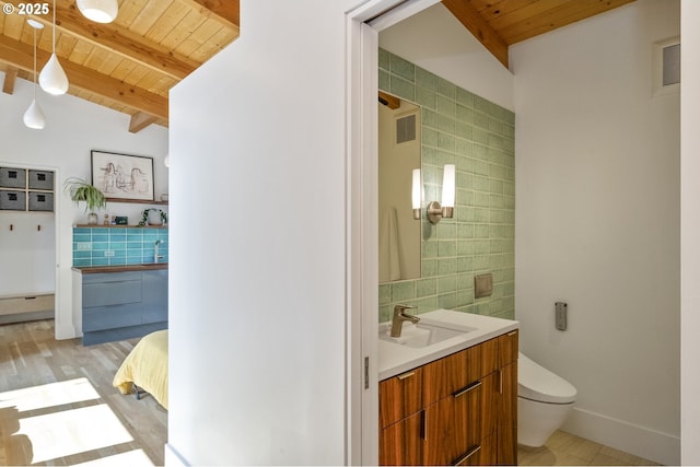 3419 SE Woodward St, Portland, OR 97202 - bathroom with a wooden ceiling with exposed beams, vanity, and tile walls
