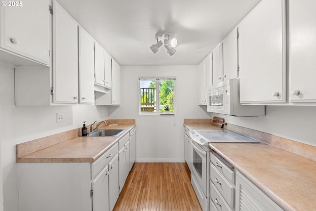 4071 Donald St Unit E, Eugene, OR 97405 - kitchen with white appliances, light wood-style floors, light countertops, and white cabinetry