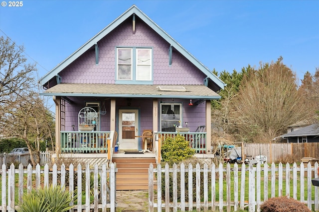 view of front of house with a fenced front yard and covered porch