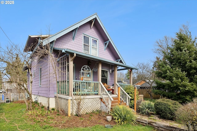 bungalow-style house with a porch and fence