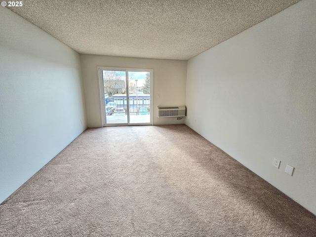 950 Evergreen Rd Unit 207, Woodburn, OR 97071 - unfurnished room with carpet floors, a wall mounted air conditioner, and a textured ceiling