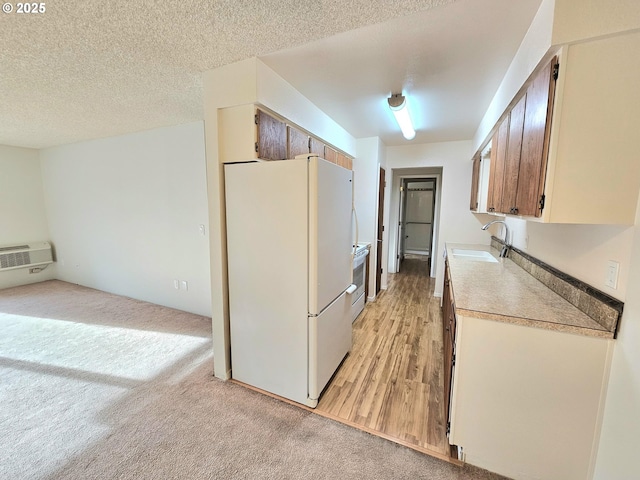 950 Evergreen Rd Unit 207, Woodburn, OR 97071 - kitchen with white appliances, a sink, light carpet, light countertops, and a textured ceiling