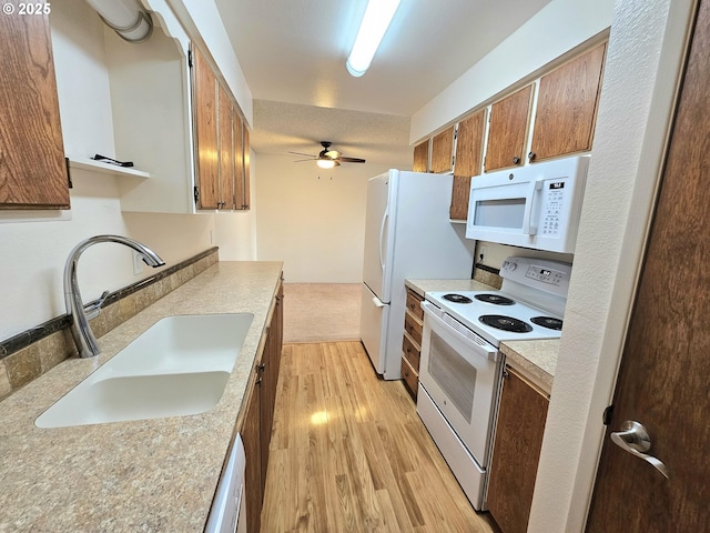 950 Evergreen Rd Unit 207, Woodburn, OR 97071 - kitchen with white appliances, a sink, light wood-type flooring, light countertops, and a ceiling fan