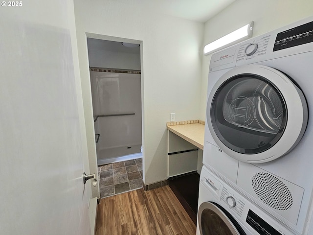 950 Evergreen Rd Unit 207, Woodburn, OR 97071 - washroom featuring stacked washer and clothes dryer, baseboards, and dark wood-style flooring