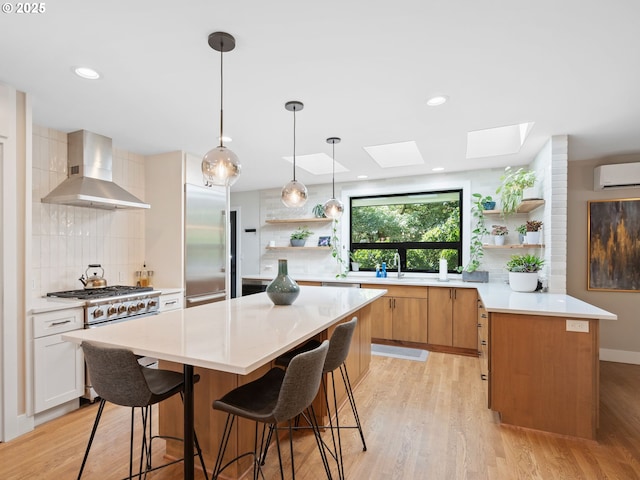 3440 SW 100th Ave, Portland, OR 97225 - kitchen featuring open shelves, wall chimney exhaust hood, a wall mounted air conditioner, a skylight, and recessed lighting