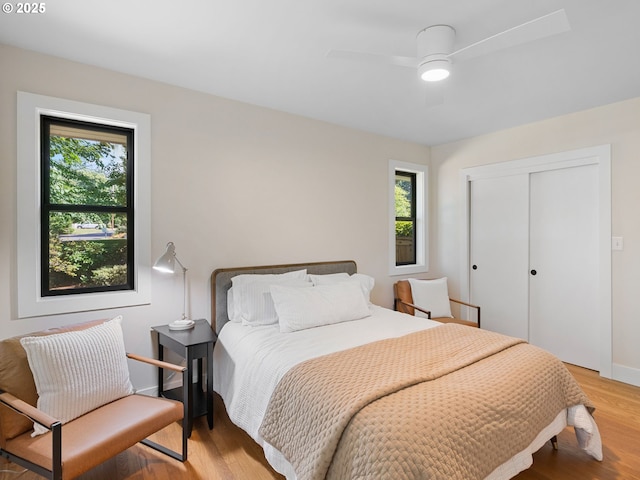 3440 SW 100th Ave, Portland, OR 97225 - bedroom featuring multiple windows, light wood finished floors, a closet, and ceiling fan