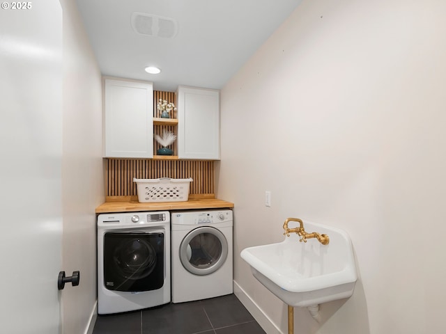 3440 SW 100th Ave, Portland, OR 97225 - laundry room featuring separate washer and dryer, dark tile patterned floors, cabinet space, and recessed lighting
