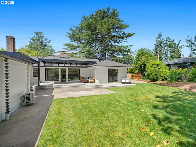 3440 SW 100th Ave, Portland, OR 97225 - rear view of property featuring a chimney, a lawn, and a patio