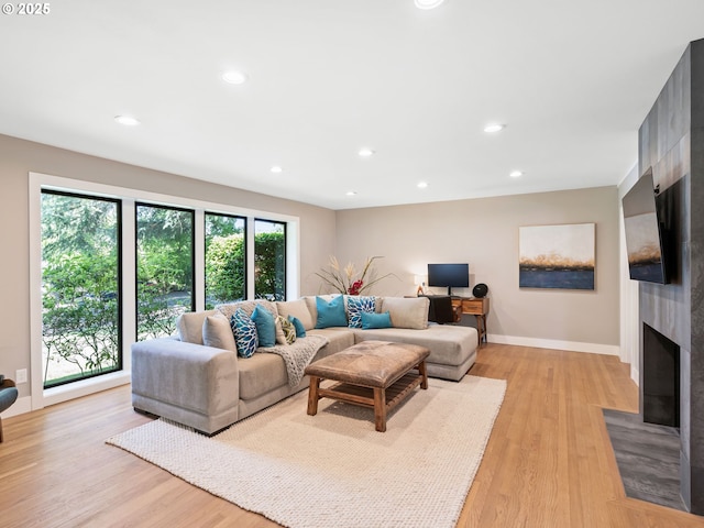 3440 SW 100th Ave, Portland, OR 97225 - living room with light wood-type flooring, recessed lighting, and a fireplace