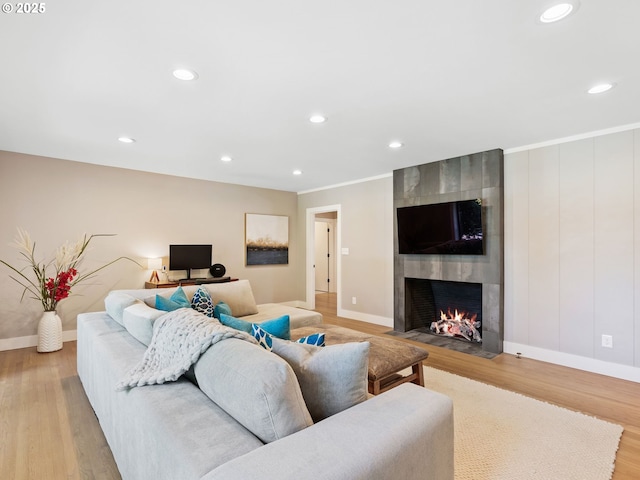 3440 SW 100th Ave, Portland, OR 97225 - living area featuring light wood-style flooring, a tiled fireplace, and recessed lighting