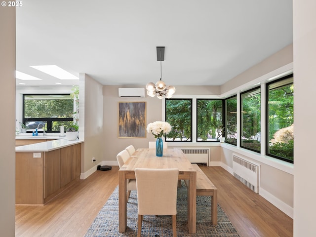 3440 SW 100th Ave, Portland, OR 97225 - dining space with radiator, a wall mounted AC, a chandelier, and plenty of natural light