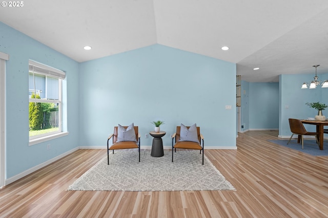 sitting room with baseboards, recessed lighting, wood finished floors, and a chandelier