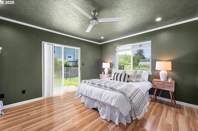 bedroom featuring access to outside, a textured ceiling, crown molding, and wood finished floors