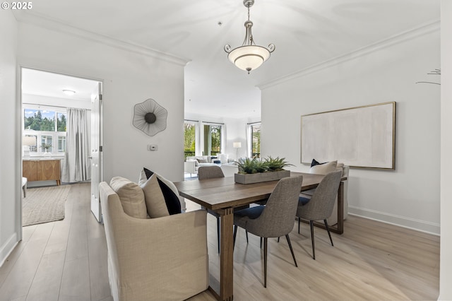 dining area with crown molding and a healthy amount of sunlight