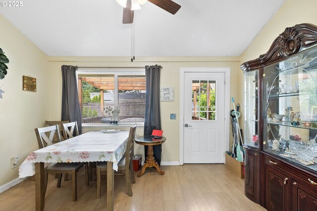 dining area featuring light wood-type flooring, baseboards, and ceiling fan