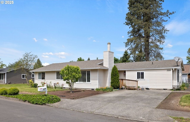ranch-style house with a chimney, concrete driveway, crawl space, and a front yard