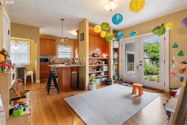 4349 NE Glisan St, Portland, OR 97213 - game room featuring light wood-style flooring, french doors, and a sink