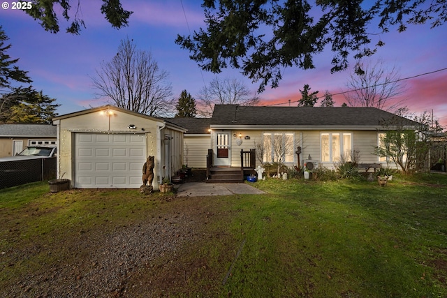 view of front of property featuring driveway, a lawn, and fence