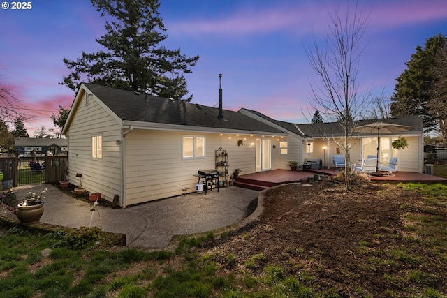 back of property featuring a patio area and fence