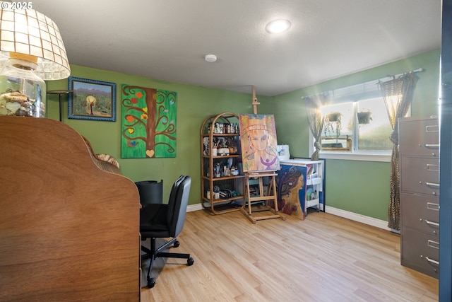 office area with baseboards and wood finished floors