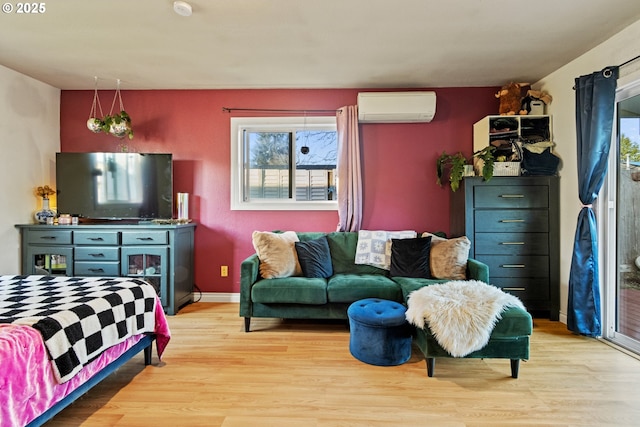 living room featuring a wall unit AC, wood finished floors, and baseboards