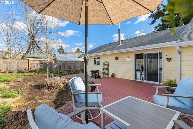 wooden deck with fence and a grill