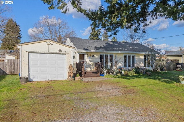 ranch-style house featuring driveway, an attached garage, fence, and a front lawn