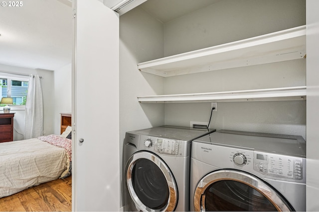 6610 SW Terri Ct Unit 10, Portland, OR 97225 - laundry room with washing machine and dryer and wood finished floors