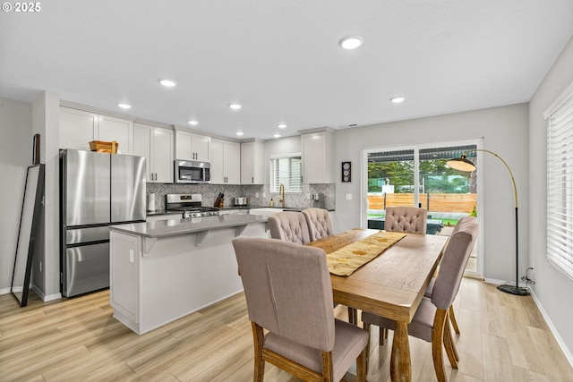 5820 El Mar Ave, Lincoln City, OR 97367 - dining space featuring light wood finished floors, recessed lighting, and baseboards