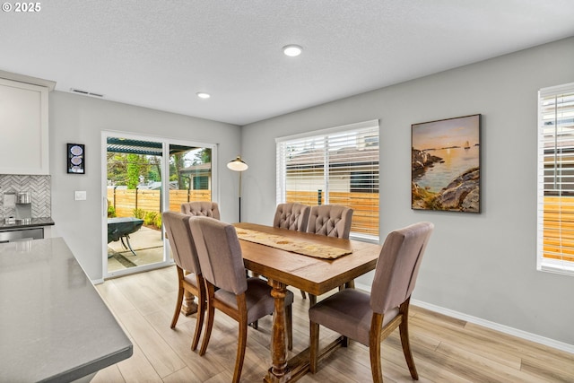 5820 El Mar Ave, Lincoln City, OR 97367 - dining space featuring light wood-style floors, healthy amount of natural light, recessed lighting, and baseboards