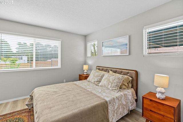 5820 El Mar Ave, Lincoln City, OR 97367 - bedroom with wood finished floors, baseboards, and a textured ceiling