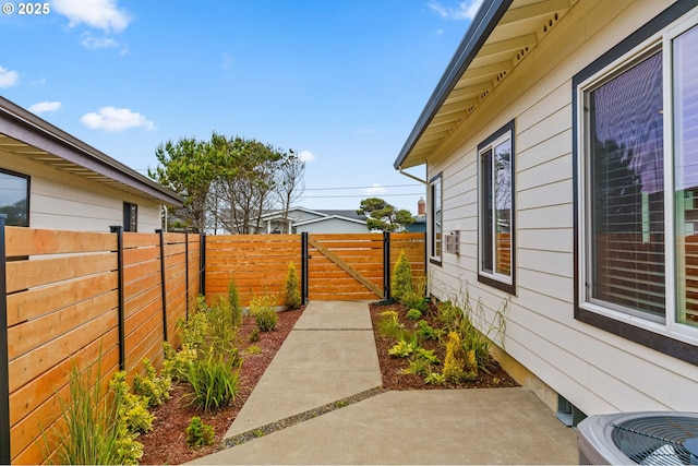 5820 El Mar Ave, Lincoln City, OR 97367 - fenced backyard featuring a patio, a gate, and central AC unit