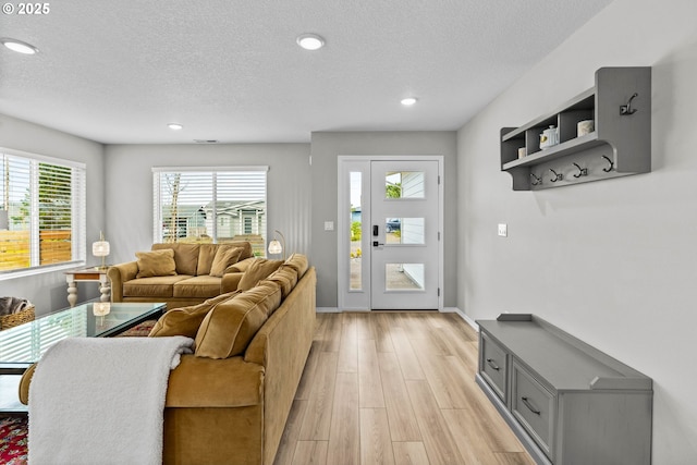 5820 El Mar Ave, Lincoln City, OR 97367 - living area featuring a textured ceiling, light wood finished floors, recessed lighting, and baseboards