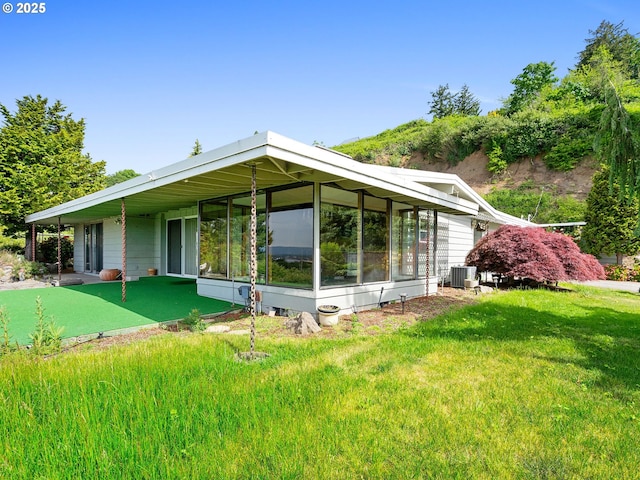 6002 E Evergreen Blvd, Vancouver, WA 98661 - view of front of home with a putting area, a front yard, and a sunroom