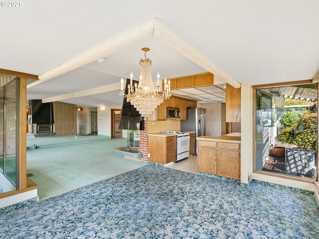 6002 E Evergreen Blvd, Vancouver, WA 98661 - kitchen featuring appliances with stainless steel finishes, light colored carpet, a chandelier, open floor plan, and hanging light fixtures